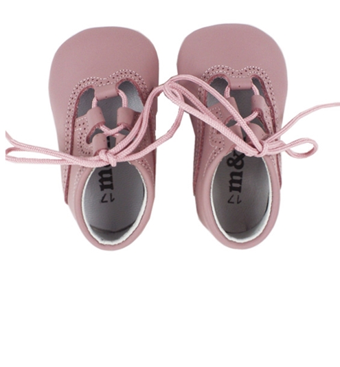 Baby shoes in pastel pink